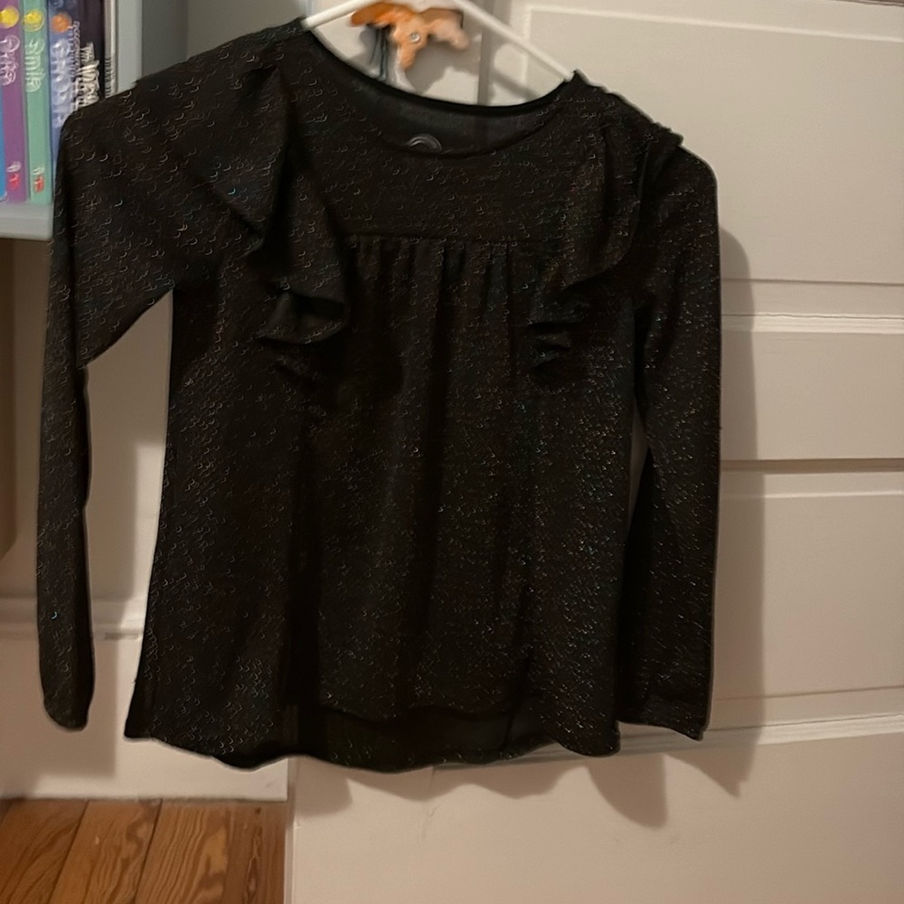 A black long sleeve flutter top shirt covered in glitter and sparkles for girls.